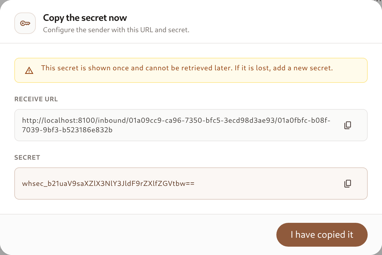 The one-time secret dialog showing the receive URL and the secret with copy buttons